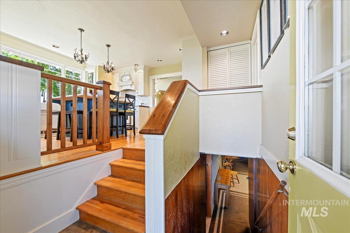 19234 Top Road Caldwell, ID 83607 - Photo 6 of 50 Stairs with wood finished floors and a chandelier