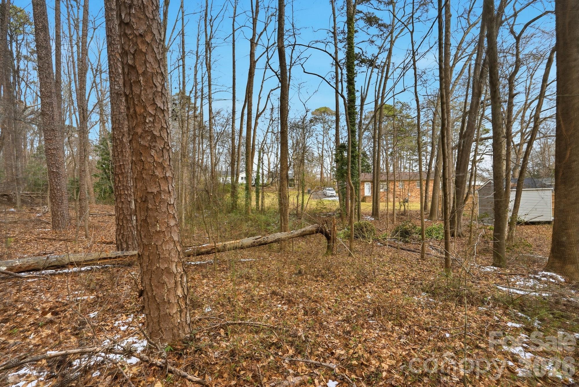 0 West Border Street Dallas, NC 28034 - Photo 17 of 21 a backyard of a house with lots of green space and glass windows