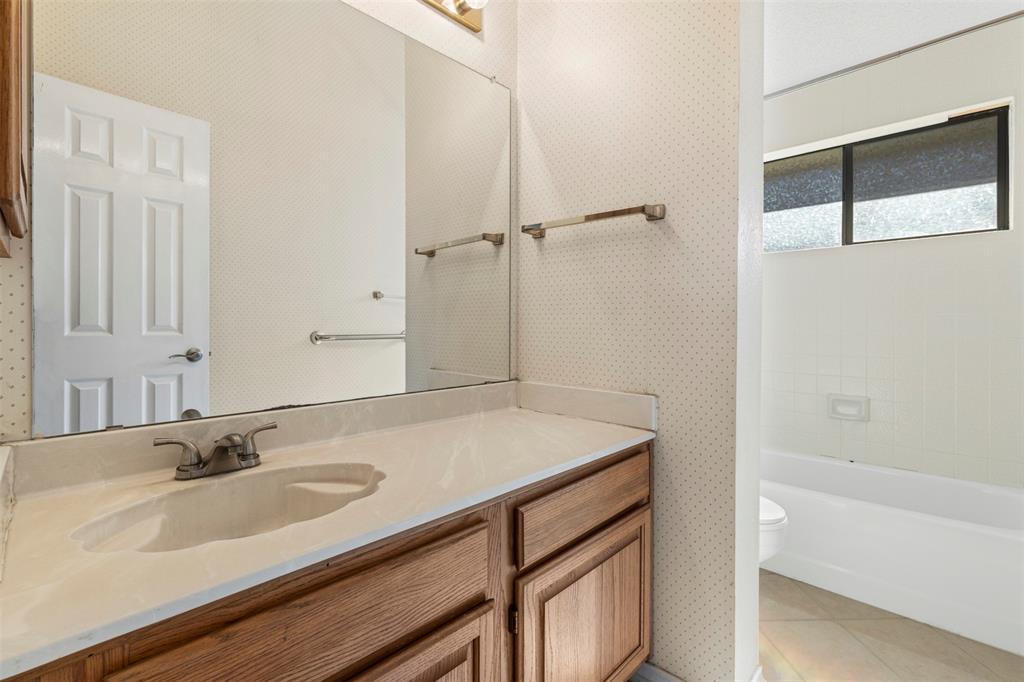 6905 Rochelle Drive Plano, TX 75023 - Photo 18 of 23 a bathroom with a sink and a bathtub