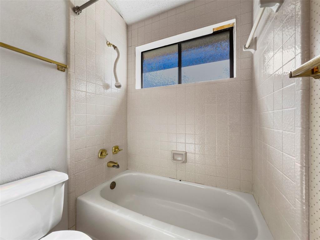 6905 Rochelle Drive Plano, TX 75023 - Photo 19 of 23 a bathroom with a bathtub and shower