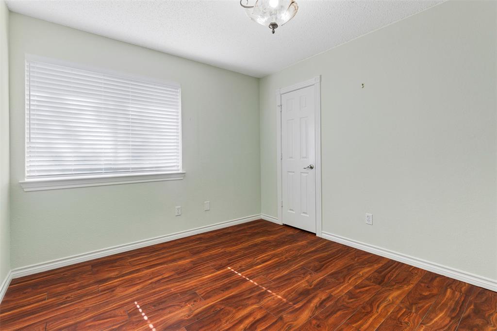 6905 Rochelle Drive Plano, TX 75023 - Photo 20 of 23 an empty room with wooden floor and windows
