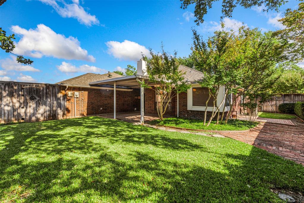 6905 Rochelle Drive Plano, TX 75023 - Photo 22 of 23 a view of a house with a backyard