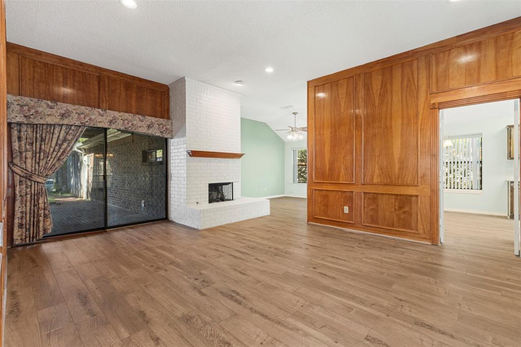 6905 Rochelle Drive Plano, TX 75023 - Photo 3 of 23 a view of a livingroom with wooden floor and a kitchen