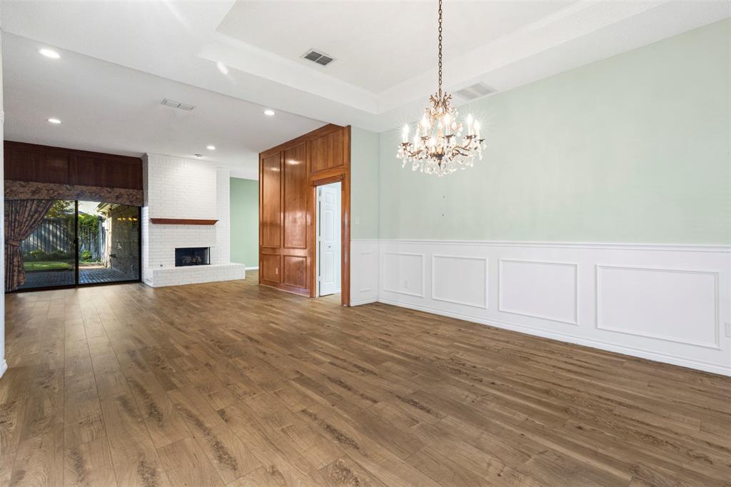 6905 Rochelle Drive Plano, TX 75023 - Photo 6 of 23 a view of a livingroom with a chandelier wooden floor and a chandelier