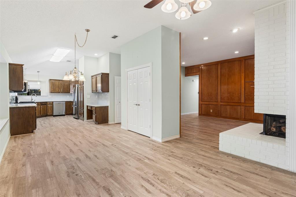 6905 Rochelle Drive Plano, TX 75023 - Photo 10 of 23 a large white kitchen with wooden floor and a refrigerator