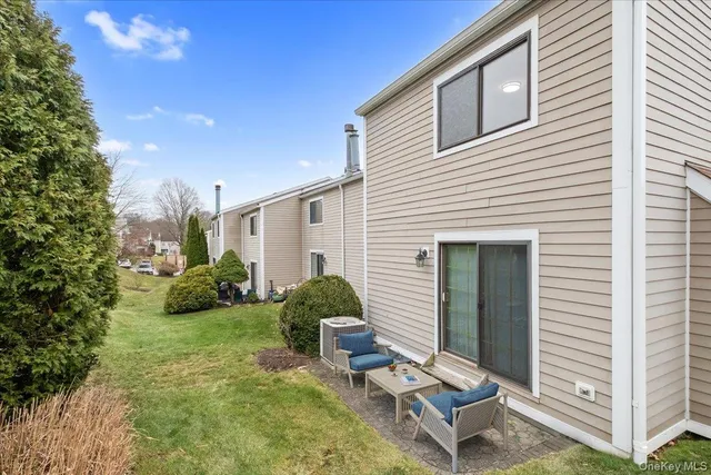 a view of a house with backyard and sitting area