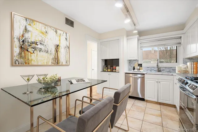 a kitchen with stainless steel appliances kitchen island granite countertop a sink and cabinets