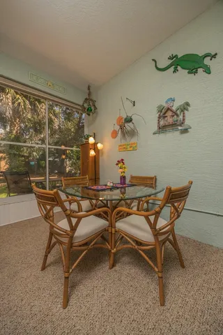 a dining room with furniture and a window
