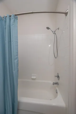 a bathroom with a shower and a bath tub