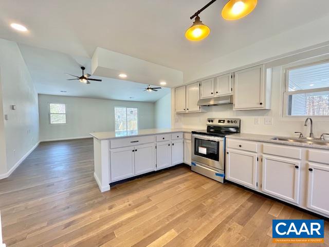6232 Howardsville Road Dillwyn, VA 23936 - Photo 13 of 35 a kitchen with stainless steel appliances white cabinets and wooden floors