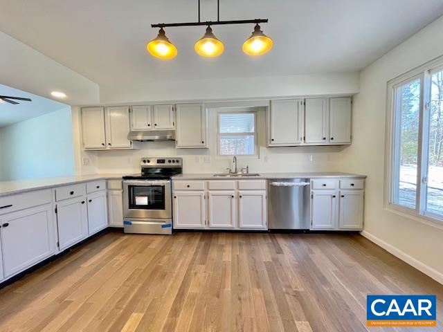 6232 Howardsville Road Dillwyn, VA 23936 - Photo 8 of 35 a kitchen with stainless steel appliances granite countertop a stove a sink and a microwave