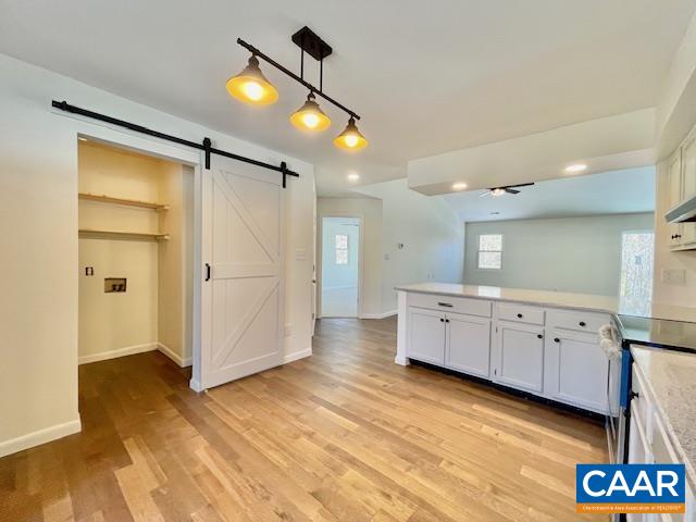 6232 Howardsville Road Dillwyn, VA 23936 - Photo 10 of 35 a kitchen with white cabinets and wooden floor