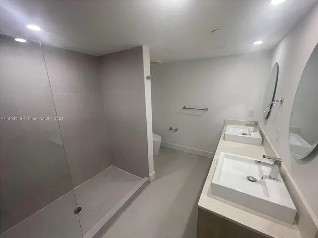 a bathroom with a shower a toilet and sink