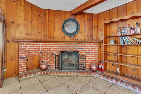 a front view of a fireplace with grey walls