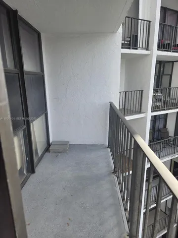 a view of staircase with white walls and railing
