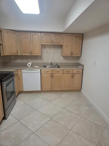 a stove top oven sitting inside of a kitchen