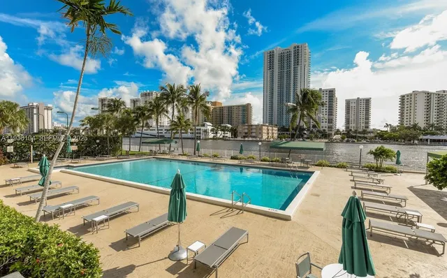 a view of a swimming pool with outdoor seating