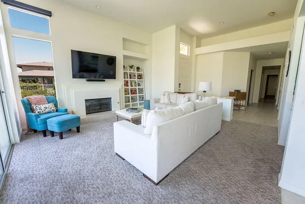 a living room with furniture a flat screen tv and a fireplace