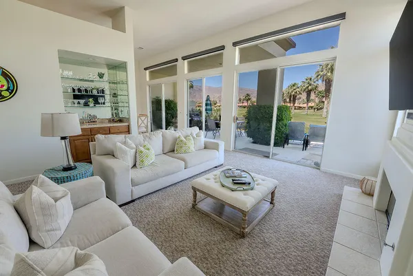 a living room with furniture lamp and window