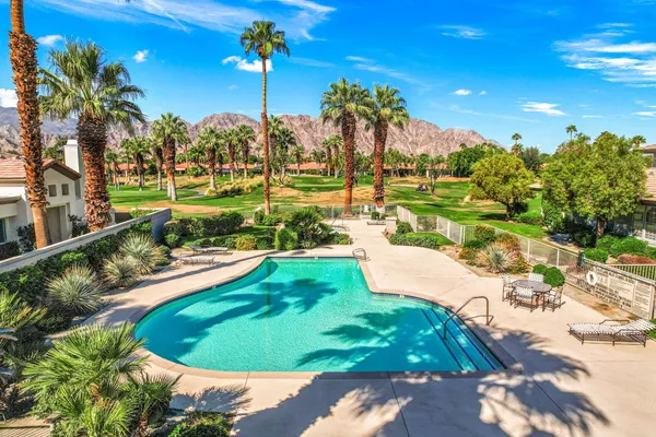 a view of a swimming pool with a yard
