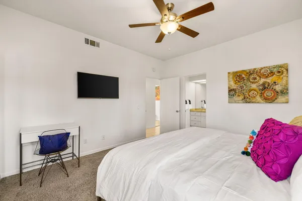 a bedroom with a bed and a flat screen tv
