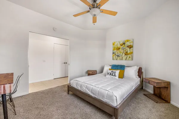 a bedroom with a bed and a table in it