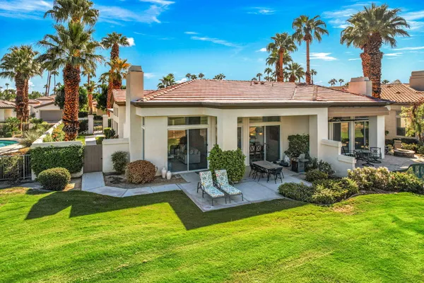 a view of a house with backyard porch and sitting area