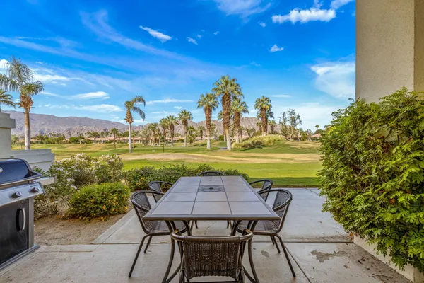 a view of a chairs and table on the patio