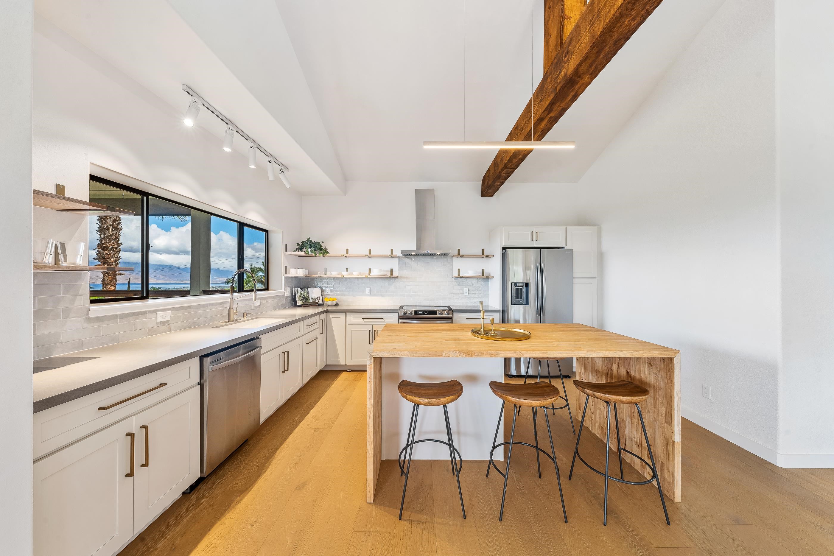 820 Kupulau Drive Kihei, HI 96753 - Photo 12 of 50 a kitchen with a table and chairs in it