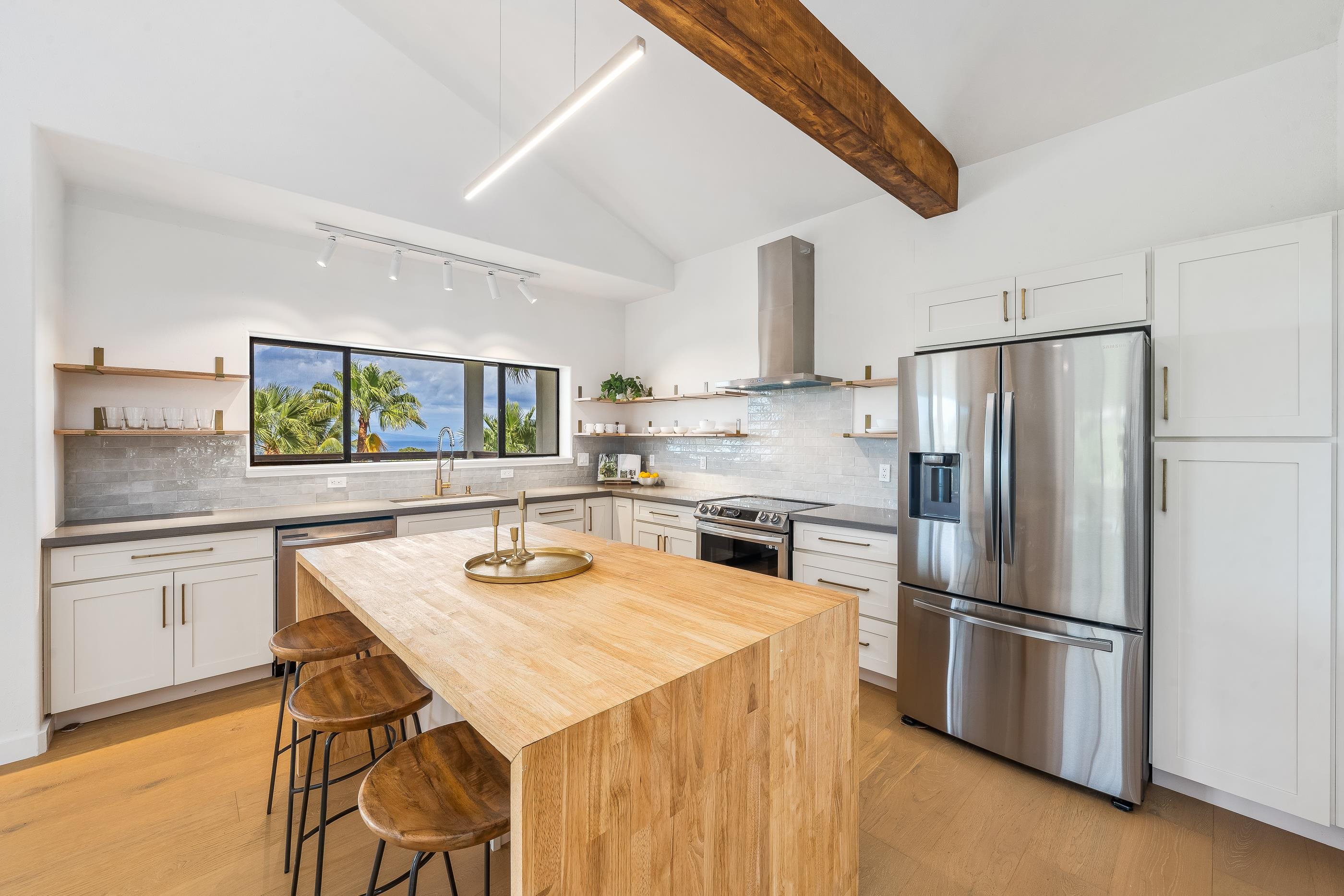 820 Kupulau Drive Kihei, HI 96753 - Photo 13 of 50 a kitchen with refrigerator cabinets and wooden floor