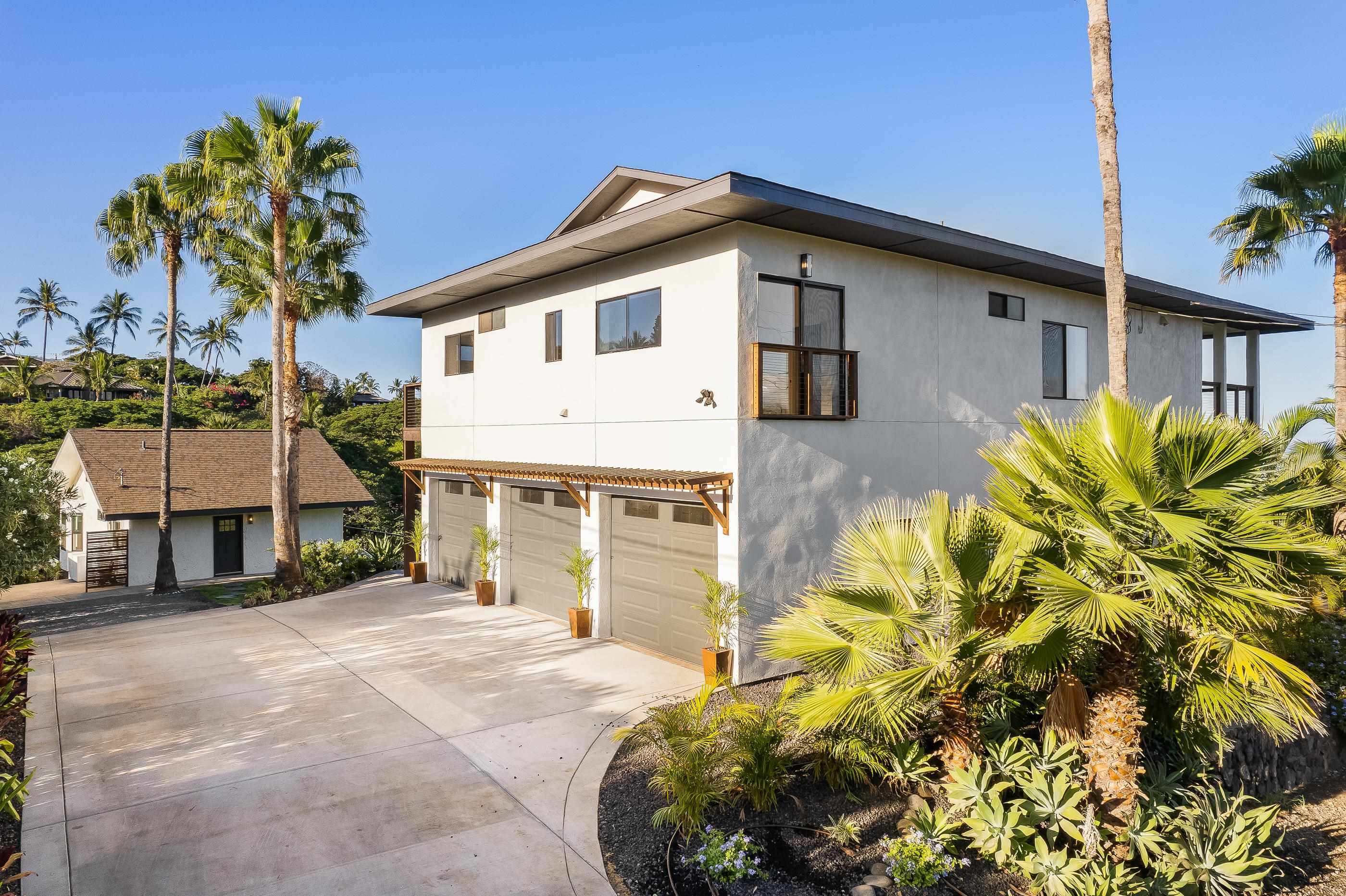 820 Kupulau Drive Kihei, HI 96753 - Photo 14 of 50 a front view of a house with a yard and garage