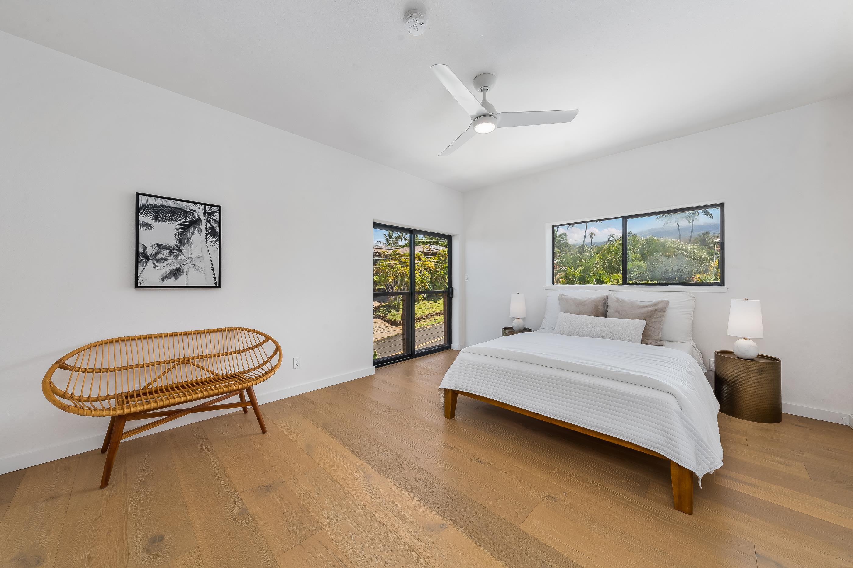 820 Kupulau Drive Kihei, HI 96753 - Photo 21 of 50 a bedroom with a bed a window and a chandelier