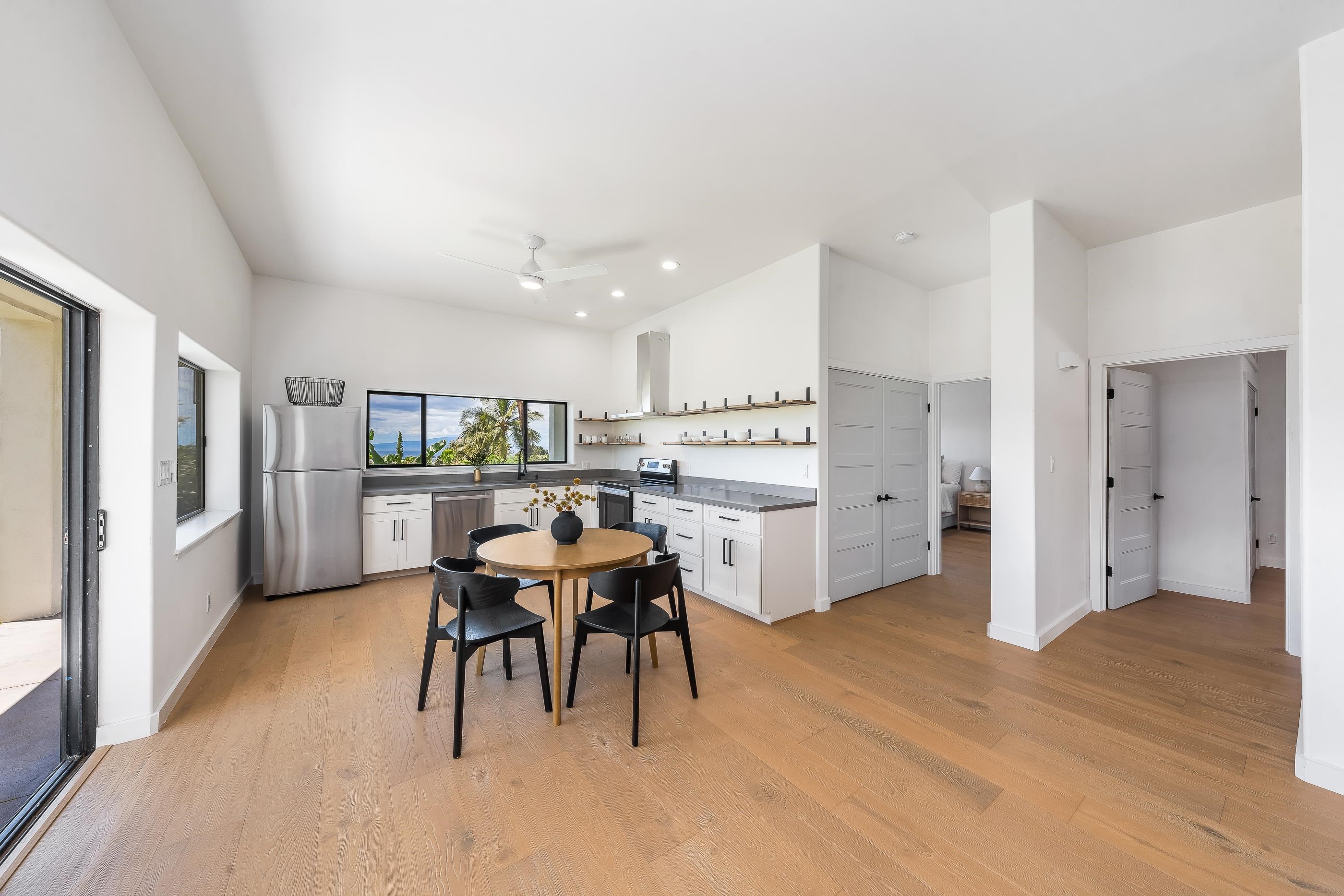 820 Kupulau Drive Kihei, HI 96753 - Photo 29 of 50 a kitchen with stainless steel appliances kitchen island granite countertop a refrigerator and a stove top oven