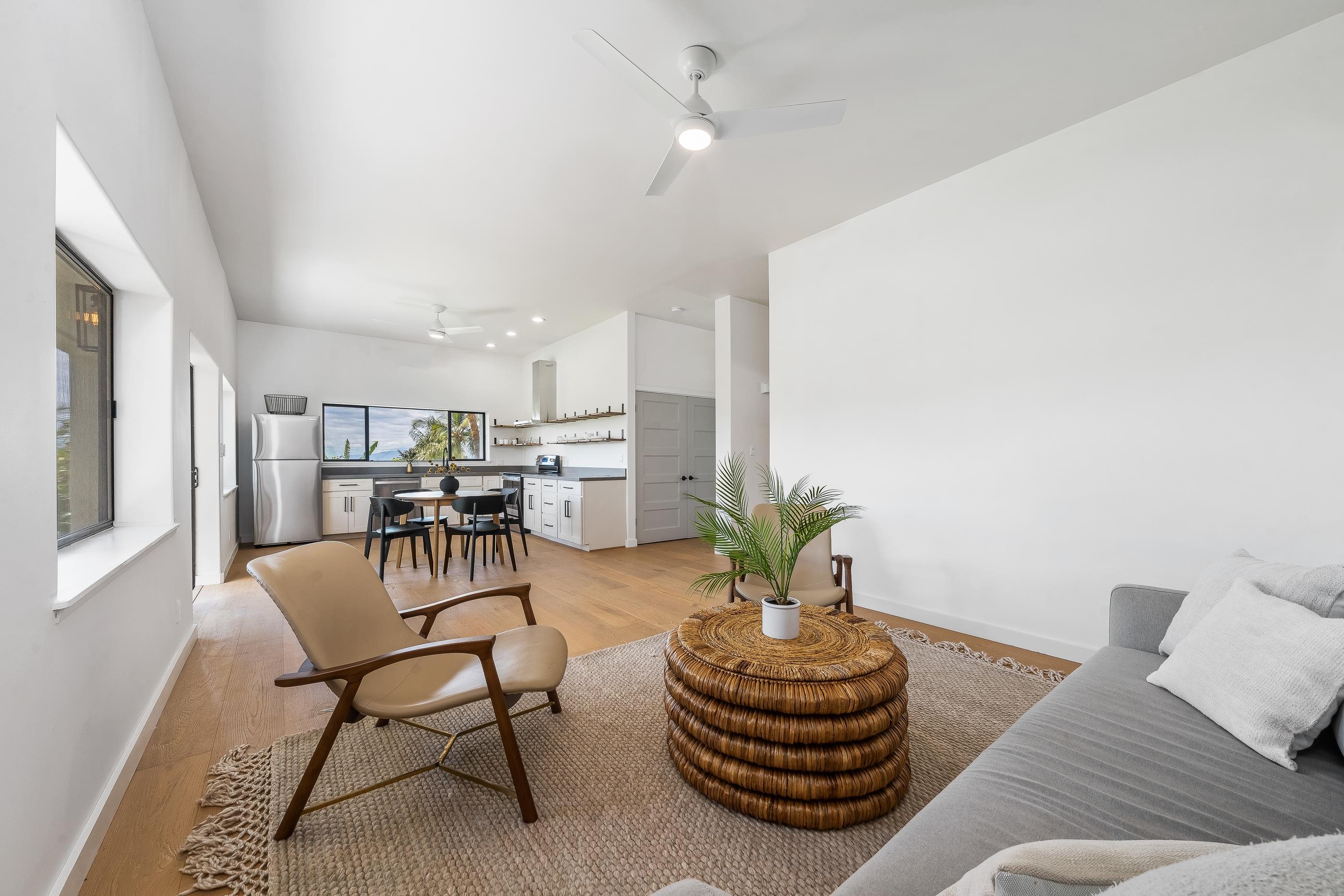 820 Kupulau Drive Kihei, HI 96753 - Photo 32 of 50 a living room with furniture and a potted plant