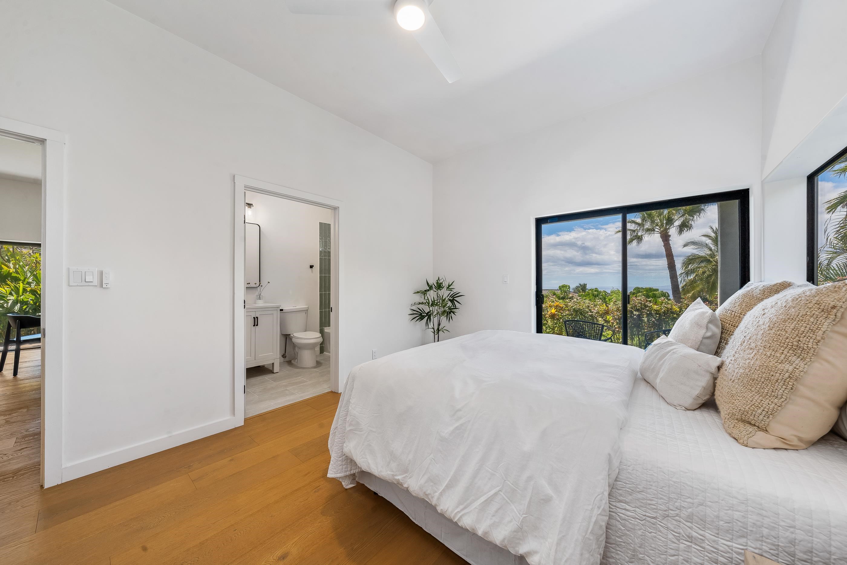 820 Kupulau Drive Kihei, HI 96753 - Photo 33 of 50 a spacious bedroom with a bed and a large window