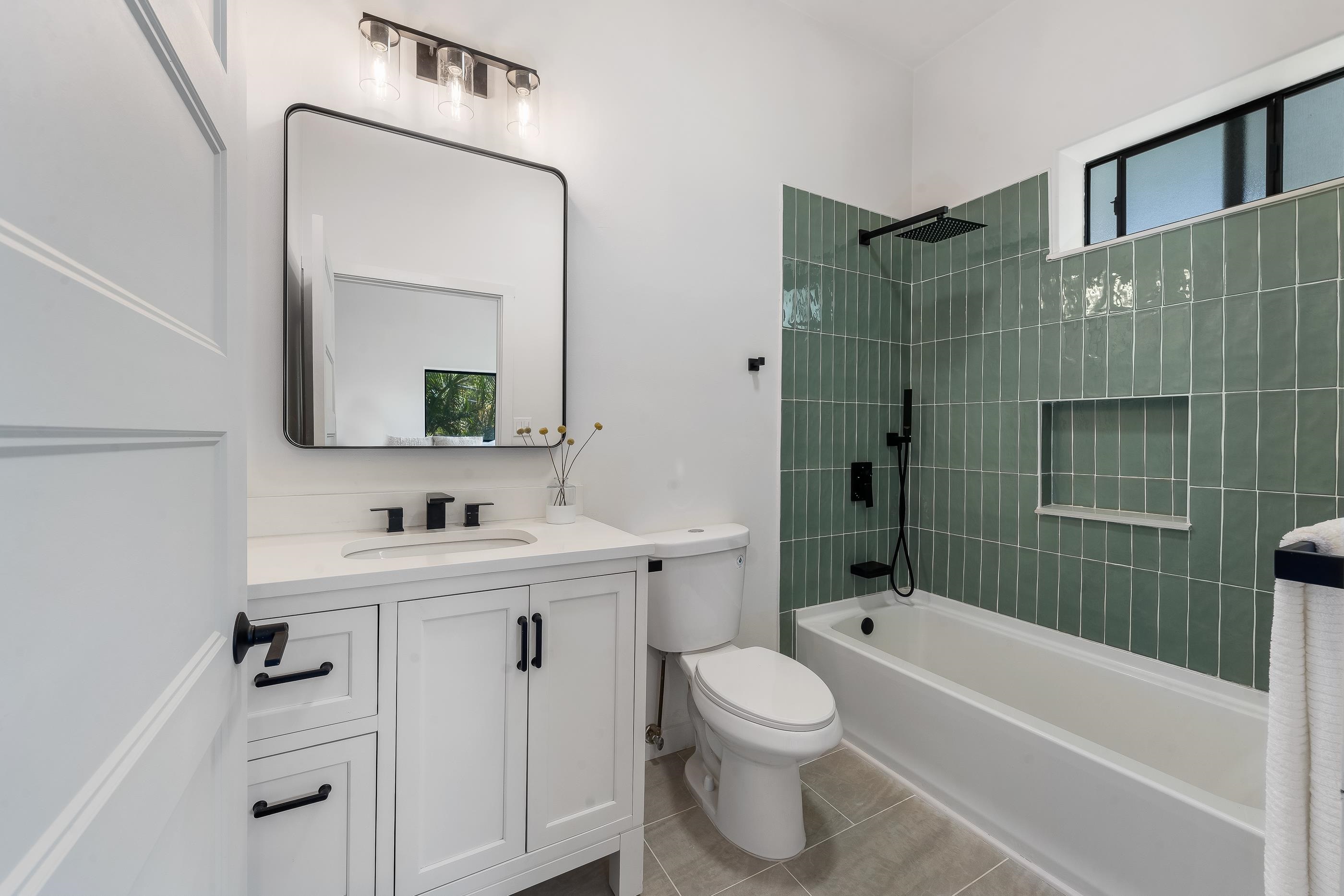 820 Kupulau Drive Kihei, HI 96753 - Photo 35 of 50 a bathroom with a toilet a sink a mirror a bathtub and shower