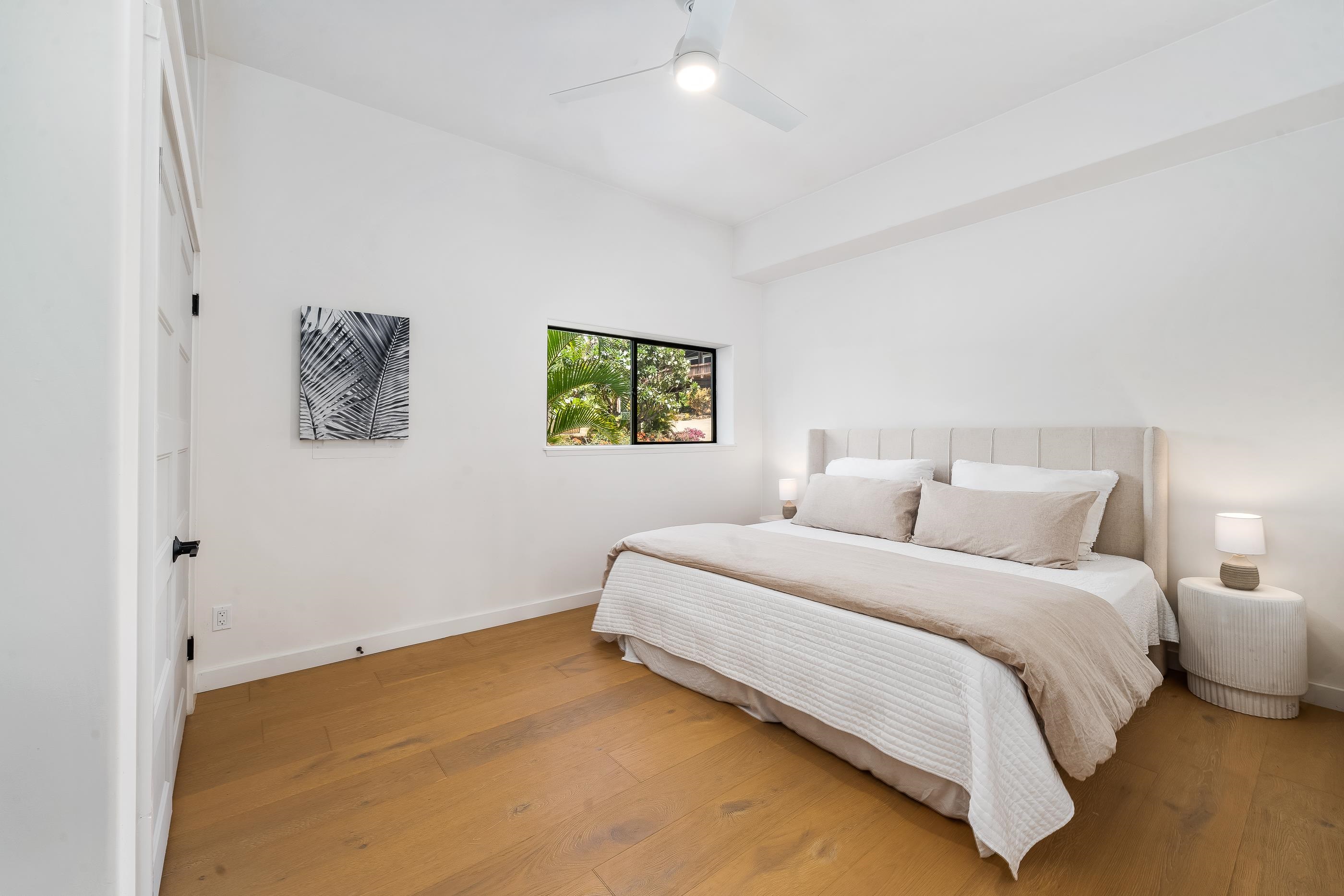 820 Kupulau Drive Kihei, HI 96753 - Photo 36 of 50 a bedroom with a bed and painting on the wall