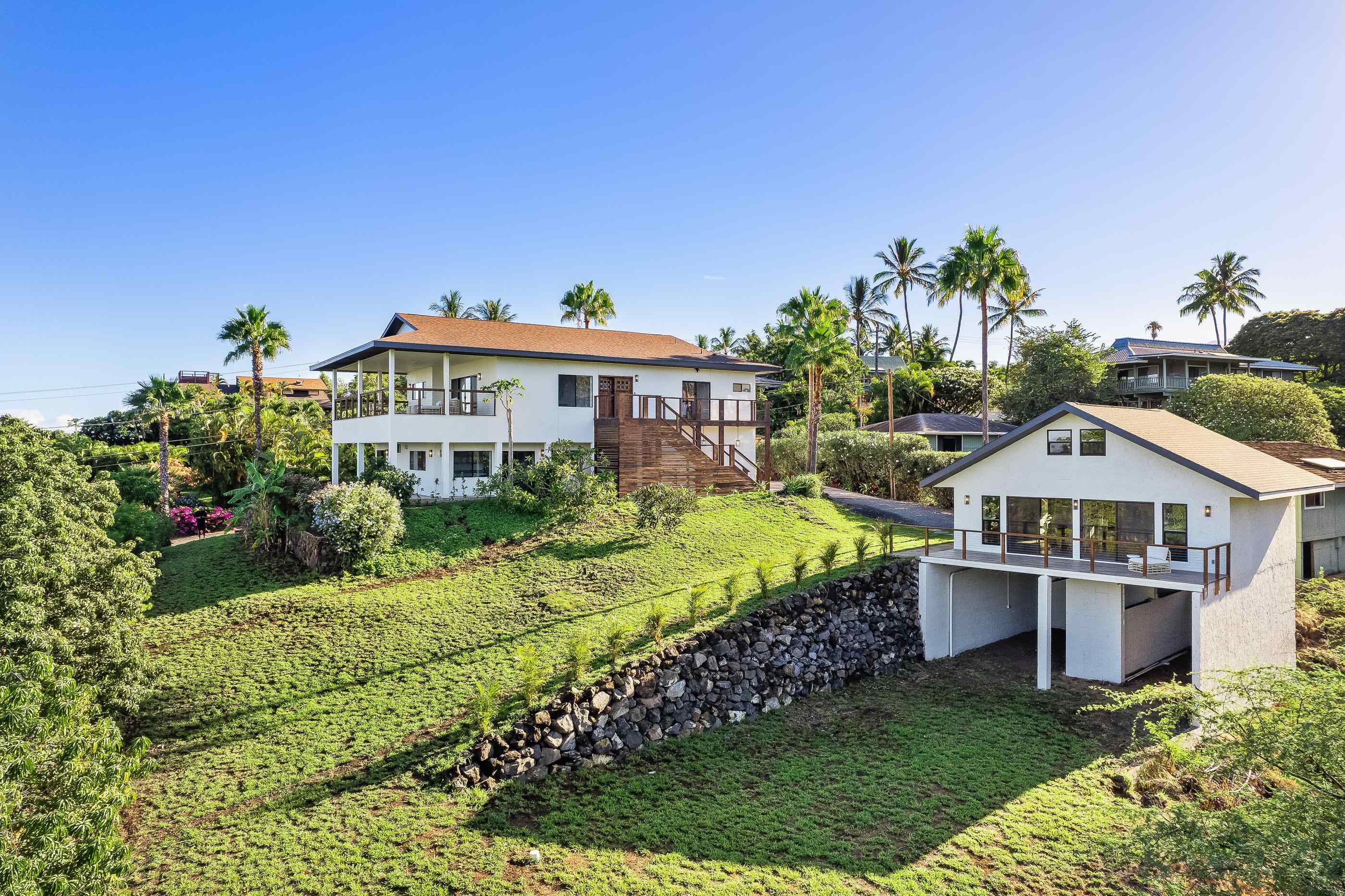 820 Kupulau Drive Kihei, HI 96753 - Photo 38 of 50 a front view of a house with a garden