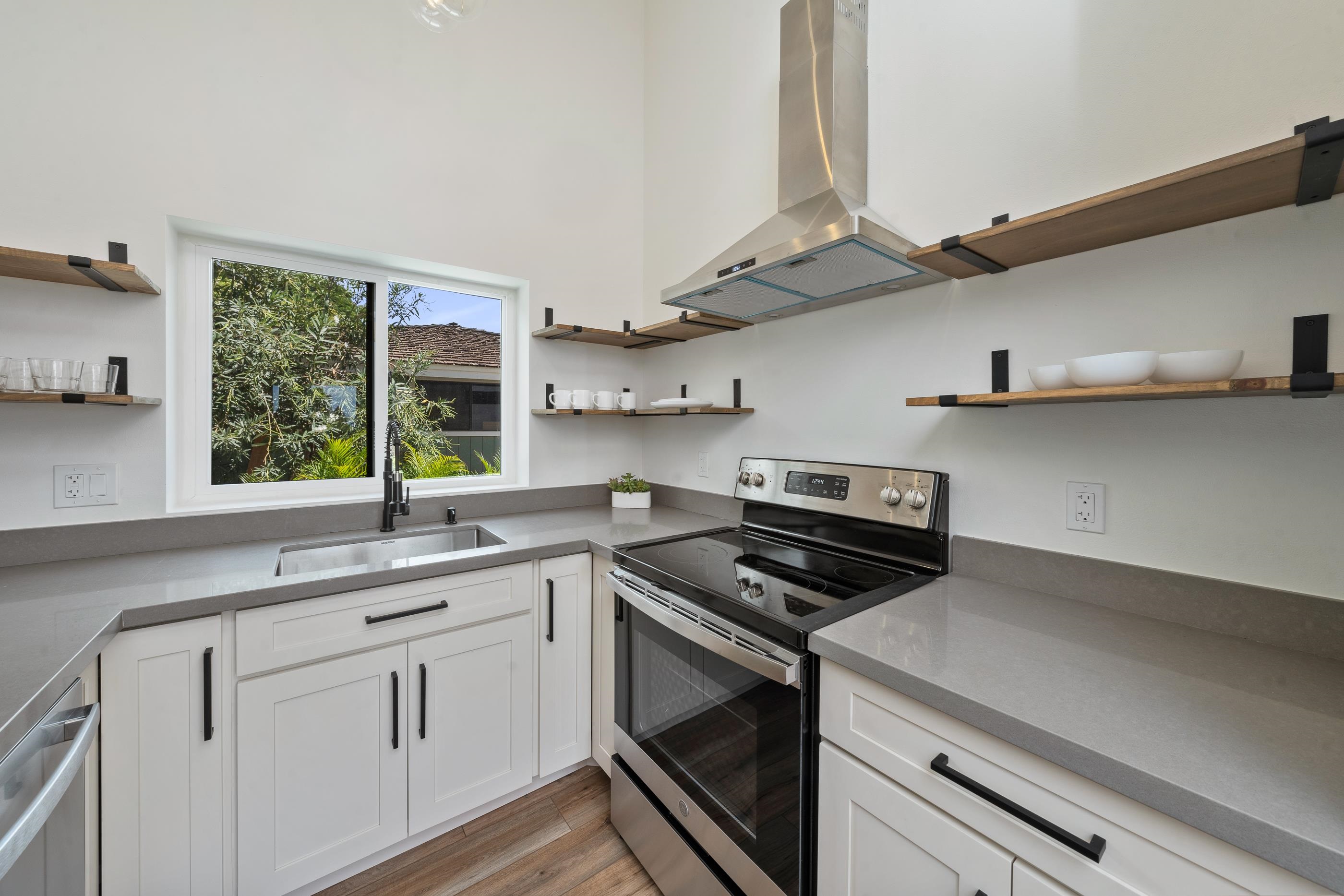 820 Kupulau Drive Kihei, HI 96753 - Photo 42 of 50 a kitchen with stainless steel appliances a sink a stove and a window