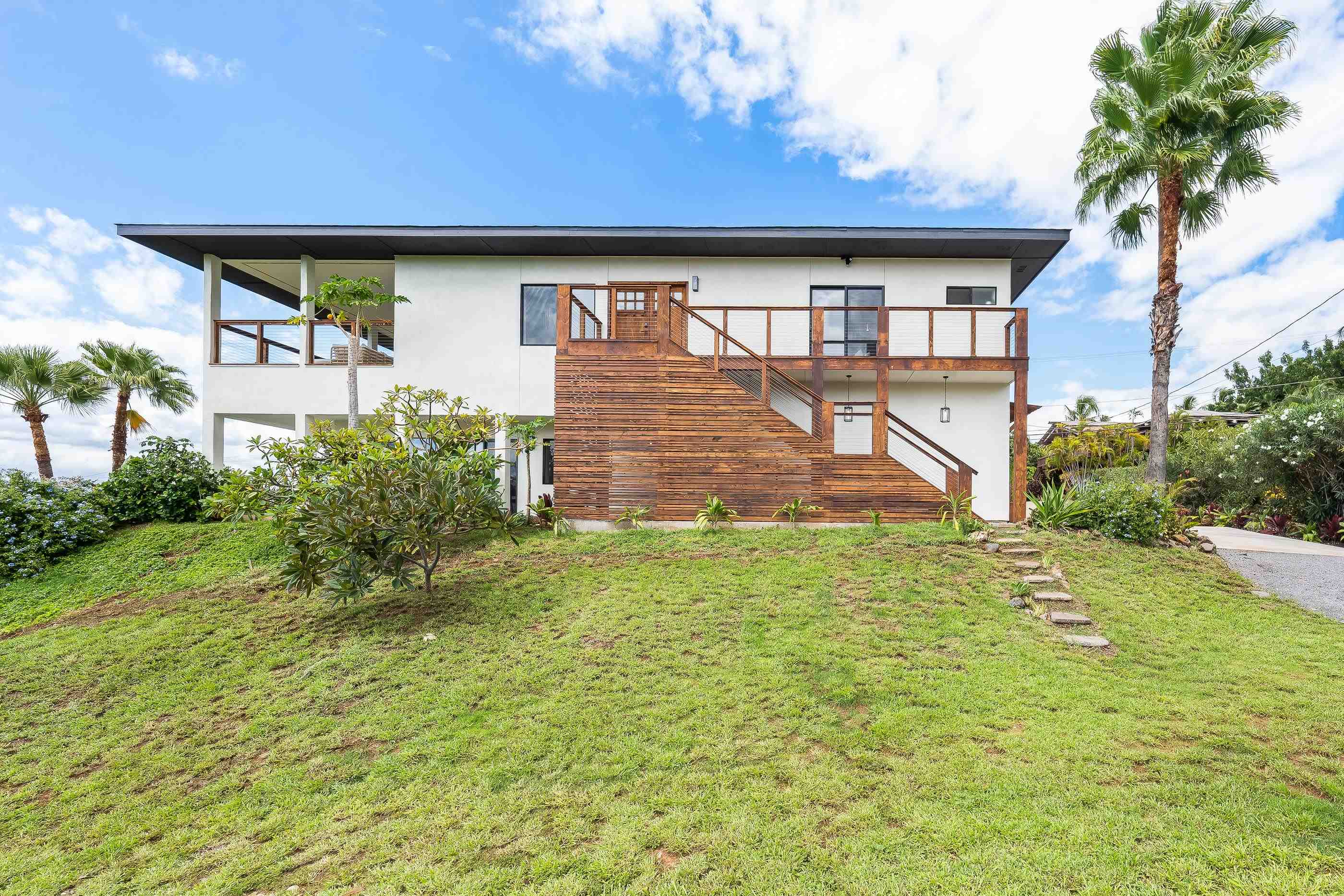 820 Kupulau Drive Kihei, HI 96753 - Photo 49 of 50 a front view of a house with garden