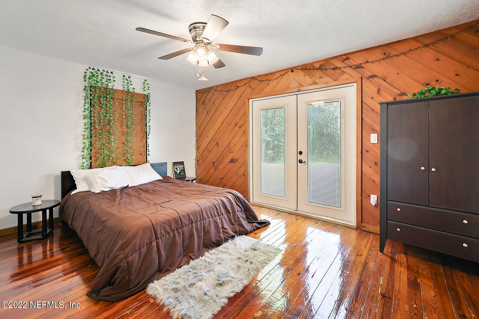 574 Clifton Road Crescent City, FL 32112 - Photo 12 of 38 a bedroom with a bed and a chandelier