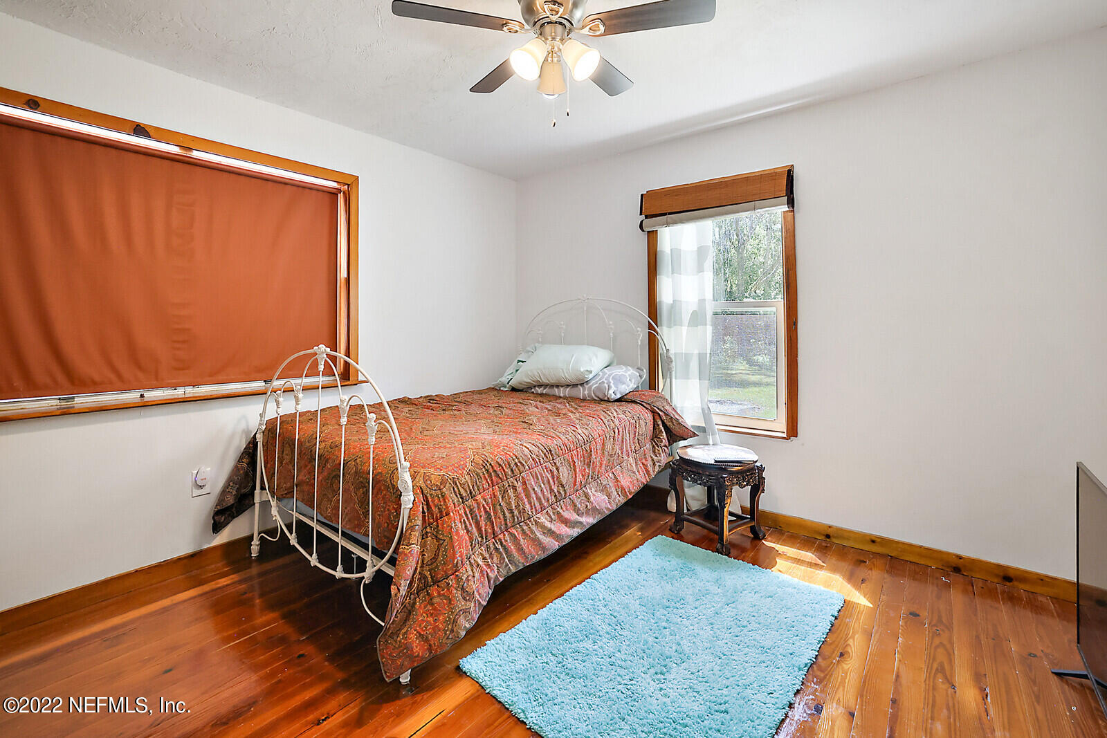 574 Clifton Road Crescent City, FL 32112 - Photo 13 of 38 a bed sitting in a bedroom next to a window