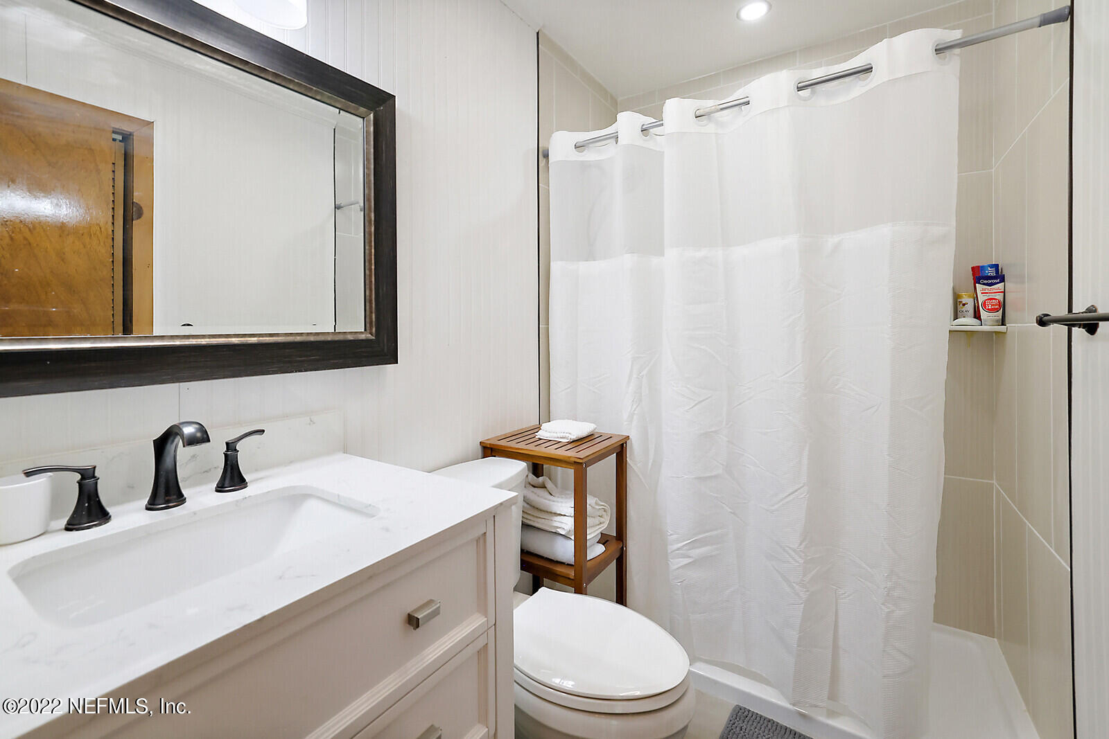 574 Clifton Road Crescent City, FL 32112 - Photo 14 of 38 a bathroom with a sink a toilet and shower curtain