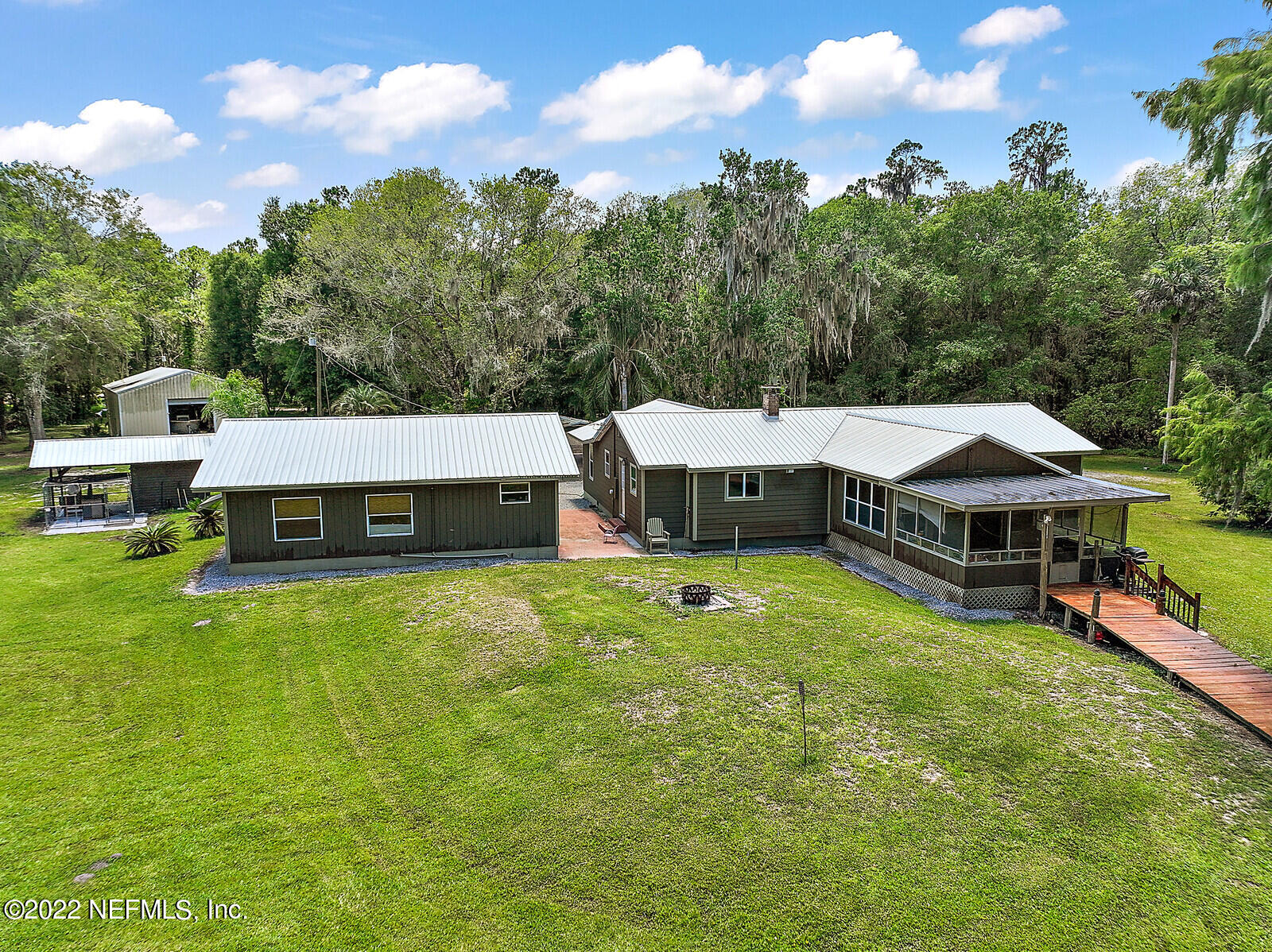 574 Clifton Road Crescent City, FL 32112 - Photo 4 of 38 a view of a house with swimming pool and yard