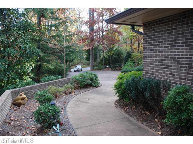 5500 East Rockingham Road Greensboro, NC 27407 - Photo 4 of 16 Exterior Front. View outside front covered door area looking down driveway.