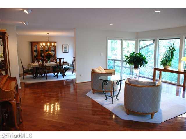 5500 East Rockingham Road Greensboro, NC 27407 - Photo 7 of 16 Living Room. Off the two story foyer is the living room open to dining room. EVERY room in this house has amazing views. Gleaming hardwoods on the diagonal add architectural interest.