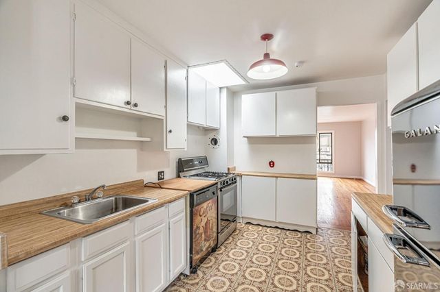 a kitchen with a sink appliances and cabinets