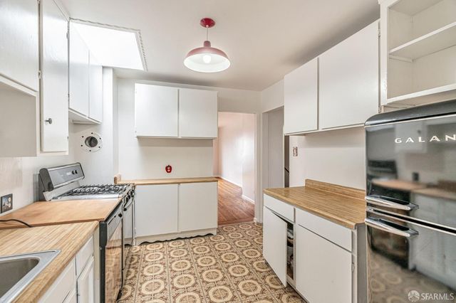 a kitchen with a sink a stove and refrigerator