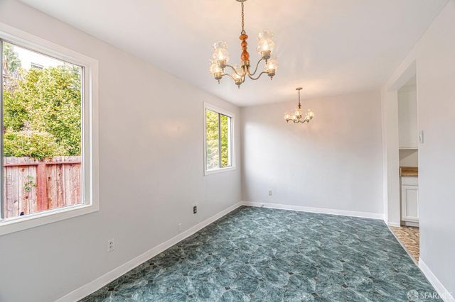 a view of a chandelier in big room with chandelier fan