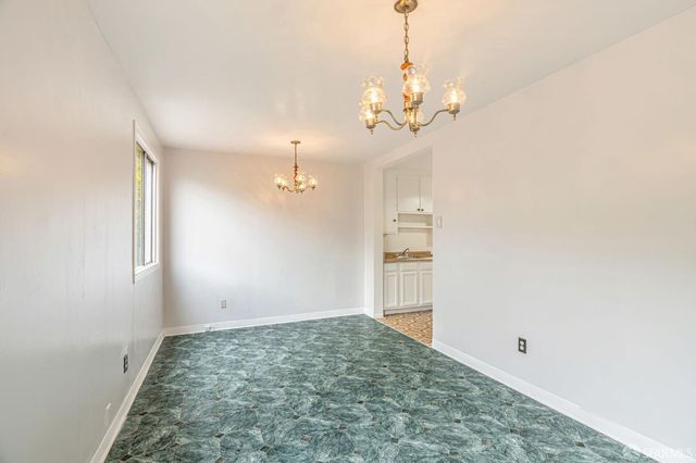 a view of a kitchen with a sink and refrigerator